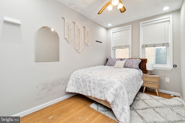 bedroom with ceiling fan and wood-type flooring