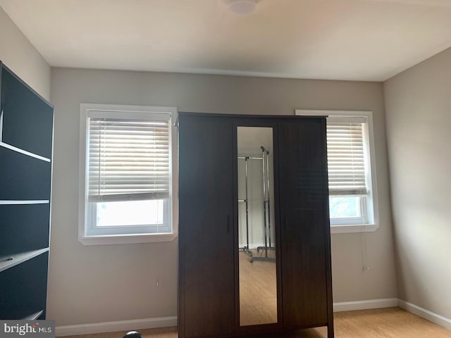 unfurnished bedroom with light wood-type flooring