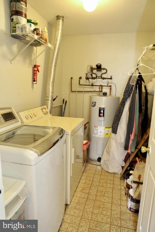 laundry area featuring washing machine and dryer and water heater