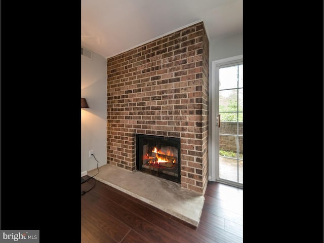 living room with a fireplace and dark hardwood / wood-style floors