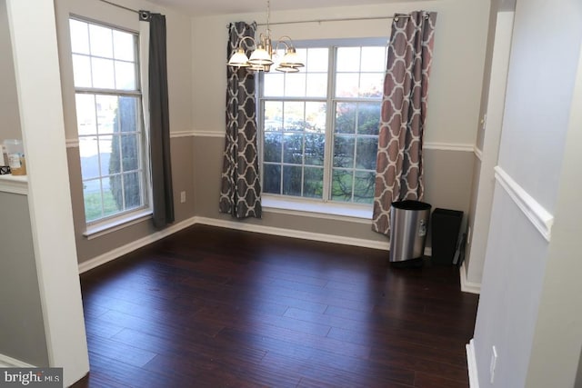 unfurnished dining area with a wealth of natural light and dark hardwood / wood-style floors