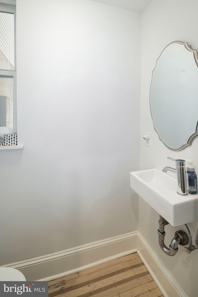 bathroom with hardwood / wood-style floors