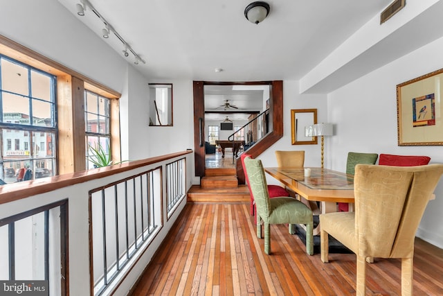 dining space featuring ceiling fan, track lighting, and light wood-type flooring