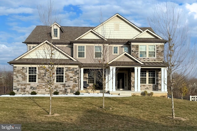 view of front of property featuring covered porch and a front yard