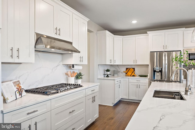 kitchen featuring sink, dark wood-type flooring, backsplash, white cabinets, and appliances with stainless steel finishes