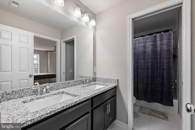 bathroom featuring tile patterned flooring, vanity, and toilet