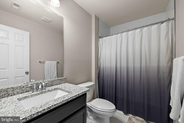 bathroom featuring tile patterned floors, vanity, and toilet