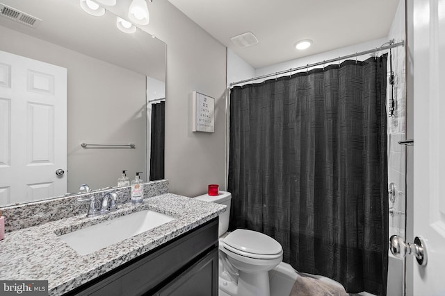 bathroom with vanity, toilet, and walk in shower