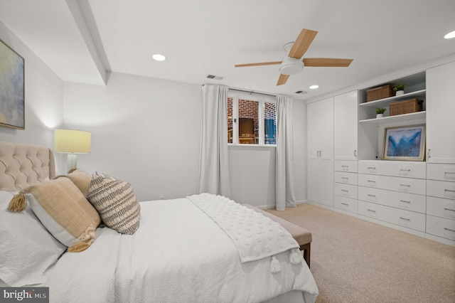 bedroom with ceiling fan and light carpet