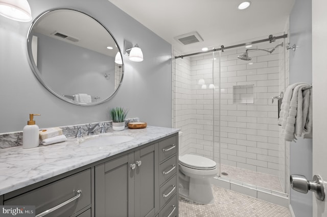 bathroom with tile patterned floors, walk in shower, vanity, and toilet