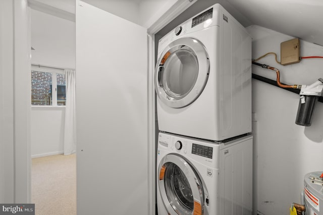 clothes washing area featuring stacked washer / drying machine