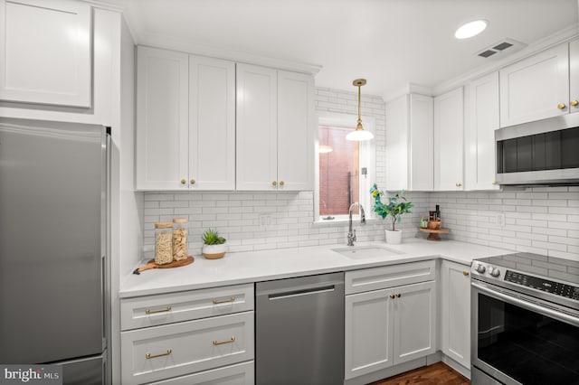 kitchen with stainless steel appliances, white cabinetry, and sink