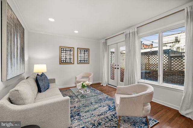 living room featuring crown molding, french doors, and dark hardwood / wood-style floors