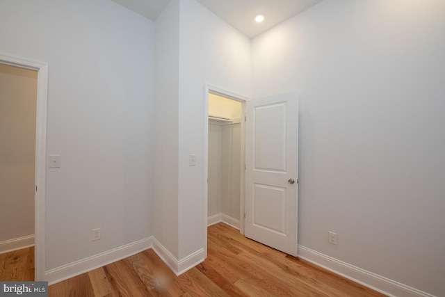 hallway with light hardwood / wood-style flooring