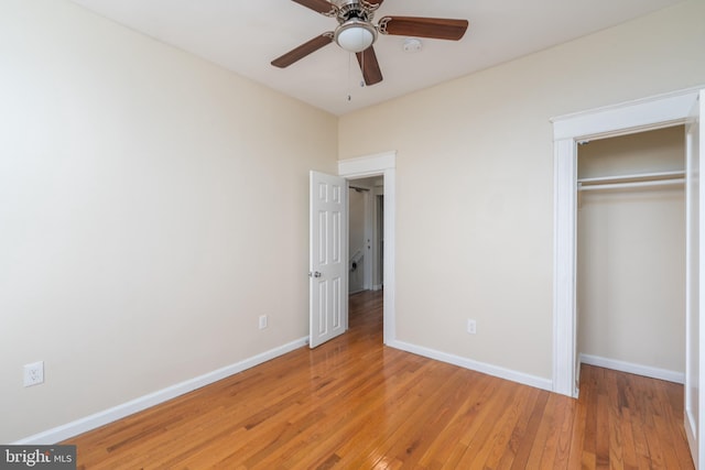 unfurnished bedroom with hardwood / wood-style flooring, a closet, and ceiling fan