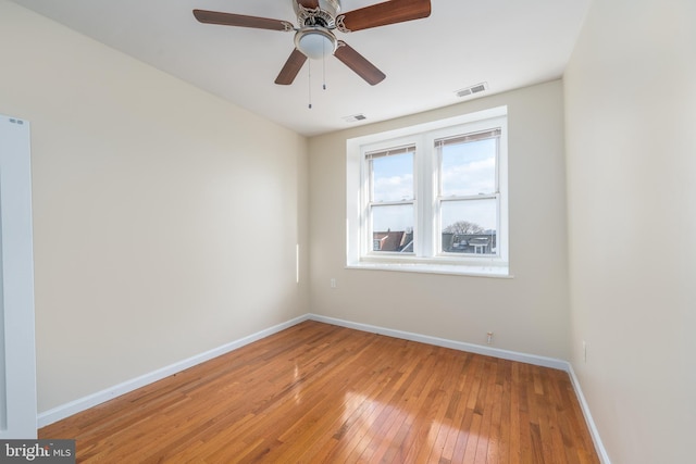 empty room featuring ceiling fan and light hardwood / wood-style floors