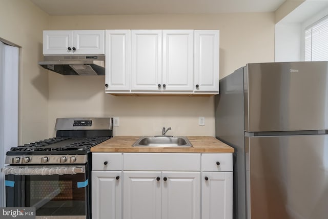 kitchen featuring white cabinetry, appliances with stainless steel finishes, and sink