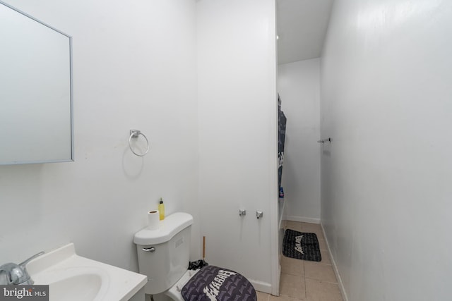 bathroom featuring tile patterned floors, toilet, and vanity