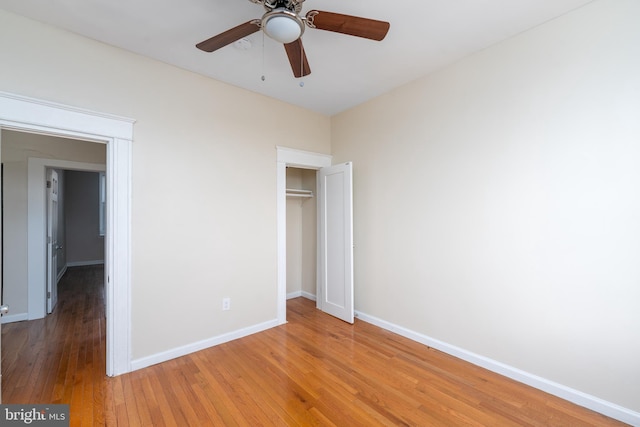 unfurnished bedroom featuring wood-type flooring, a closet, and ceiling fan