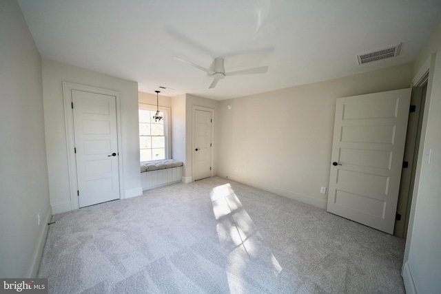 unfurnished bedroom featuring light carpet and ceiling fan