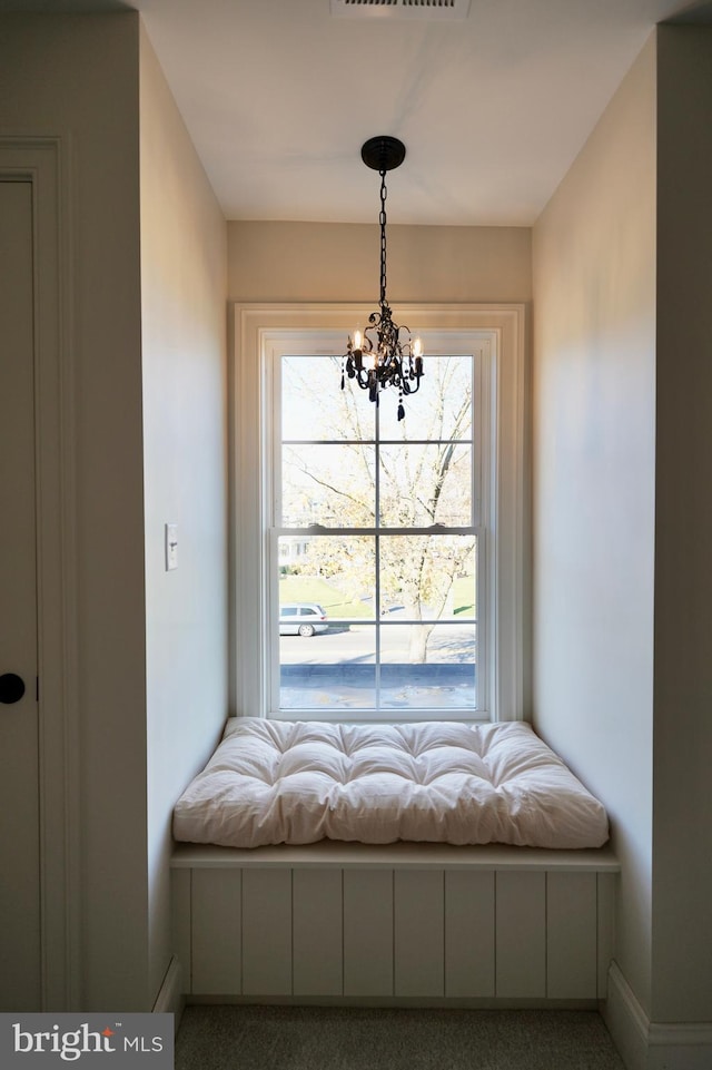 unfurnished room featuring carpet flooring and a notable chandelier