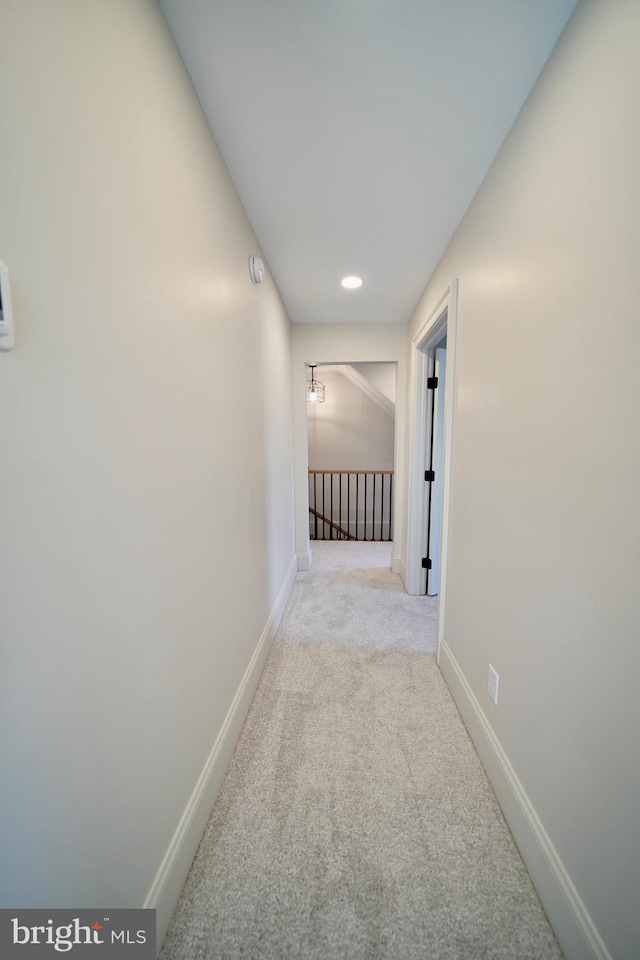 hallway featuring light carpet