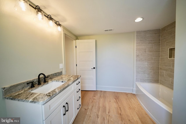 bathroom with vanity and hardwood / wood-style flooring