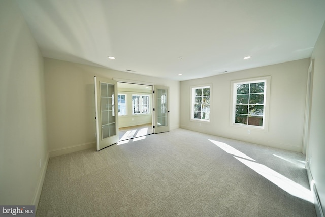 carpeted empty room with french doors