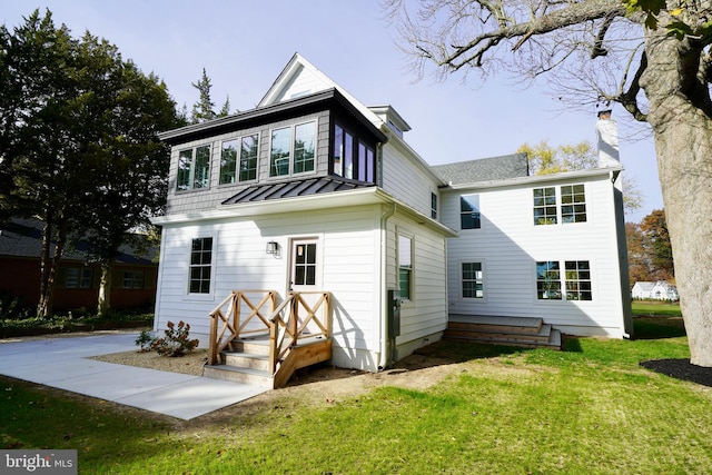 rear view of property with a yard