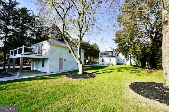 view of yard with a deck and a patio