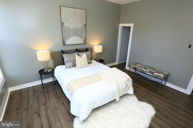 bedroom with dark wood-type flooring