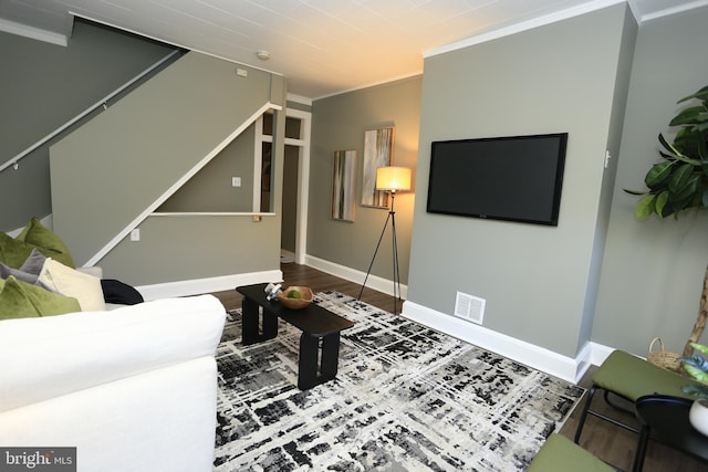 living room with hardwood / wood-style floors and crown molding