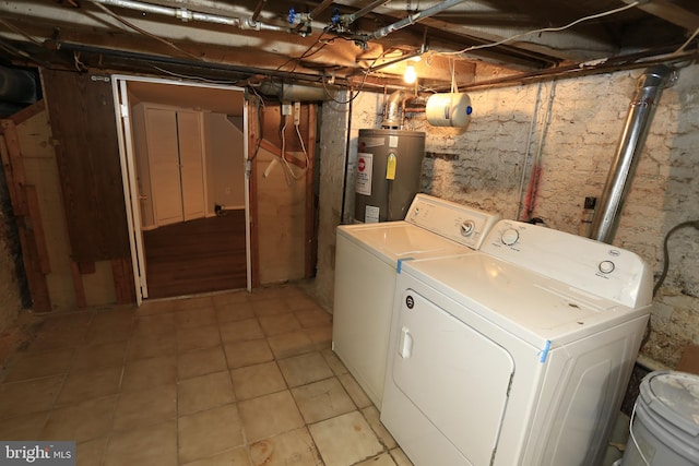 washroom featuring washing machine and dryer and water heater