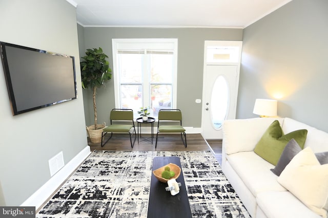 living room with hardwood / wood-style flooring and ornamental molding