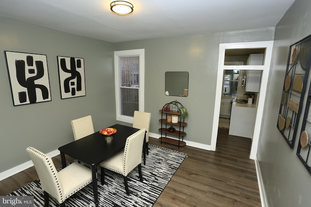 dining space with dark wood-type flooring