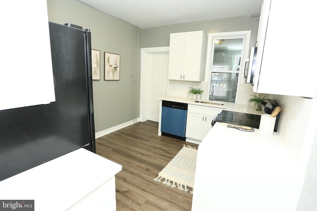 kitchen featuring sink, stainless steel dishwasher, dark hardwood / wood-style floors, white cabinets, and range