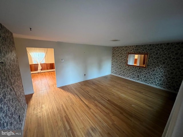 empty room with hardwood / wood-style floors