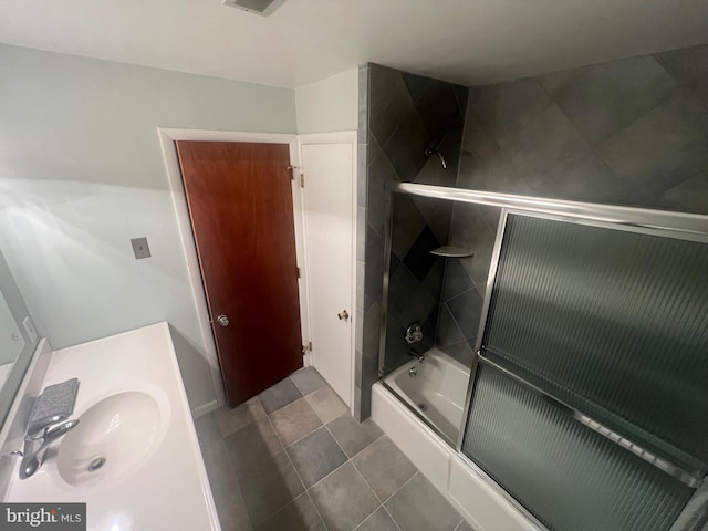 bathroom featuring shower / bath combination with glass door and sink