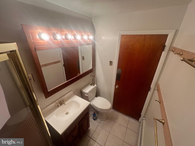 bathroom with tile patterned flooring, vanity, and toilet