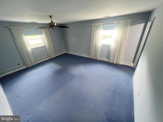 unfurnished room featuring baseboard heating, ceiling fan, and a healthy amount of sunlight