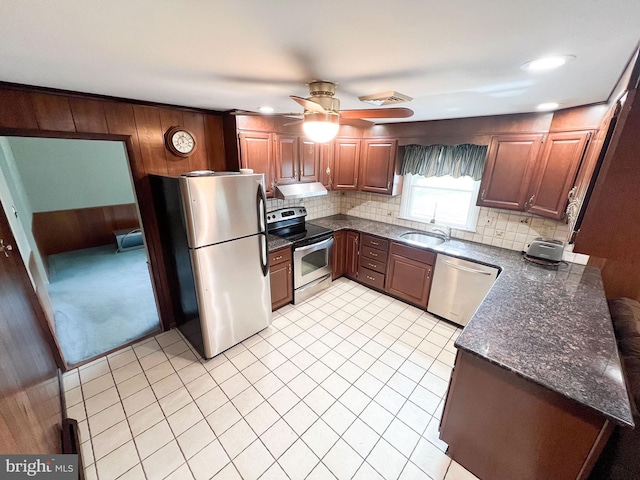 kitchen with appliances with stainless steel finishes, tasteful backsplash, ceiling fan, sink, and light tile patterned floors