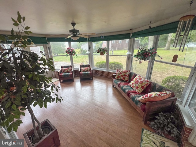 sunroom / solarium featuring plenty of natural light and ceiling fan