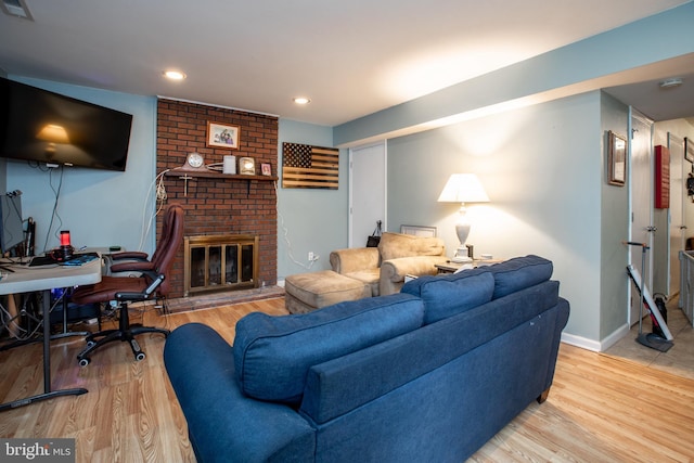 living room with hardwood / wood-style flooring and a fireplace