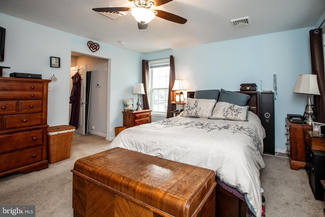 carpeted bedroom with ceiling fan and a closet