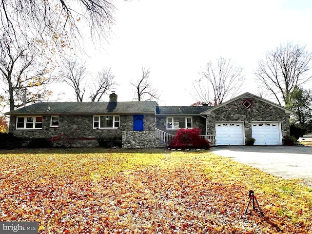 ranch-style house featuring a front lawn and a garage