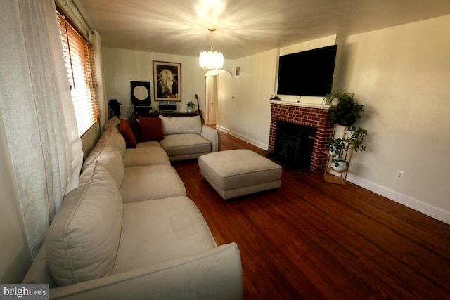 living room featuring a fireplace, hardwood / wood-style floors, and a chandelier