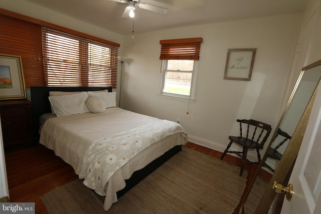 bedroom with ceiling fan and dark hardwood / wood-style flooring