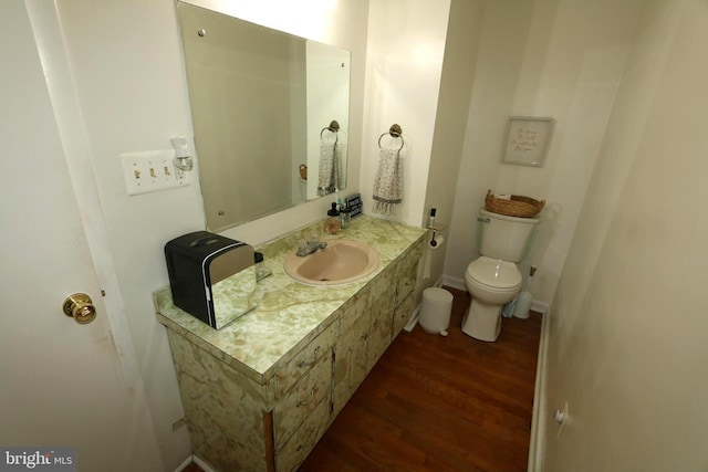 bathroom featuring vanity, wood-type flooring, and toilet