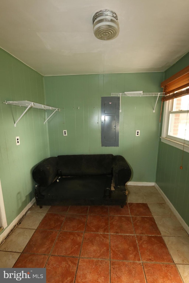 laundry area featuring tile patterned flooring and electric panel