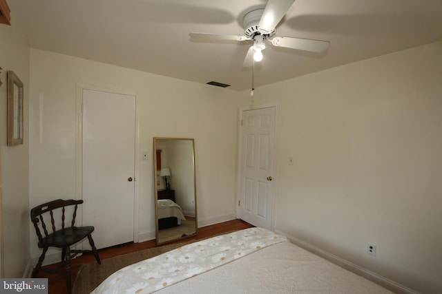 unfurnished bedroom featuring ceiling fan and dark hardwood / wood-style flooring